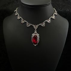 "This elegantly ornate necklace is made with antique silver tone centerpieces, featuring filigree and leaf details. Its mesmerizing design is accented with dazzling dark ruby red glass crystals with a large high quality faceted jewel hanging at its center.  Decorated portion is 8 1/2\" wide and 2 1/4\" tall in the very center.  Necklace length is adjustable with soldered stainless steel cable chain, lobster clasp and extender. If you would like a different length, please send us a message. If you don't see items with a color you want, feel free to ask about availability." Red Gothic Necklace For Formal Occasions, Formal Red Bridal Necklace With Intricate Design, Red Metal Filigree Jewelry, Antique Red Necklace For Wedding, Ornate Red Filigree Jewelry, Gothic Filigree Wedding Necklace, Gothic Filigree Necklace For Wedding, Gothic Wedding Necklaces With Jewels, Formal Red Necklaces With Intricate Design