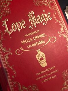 a red book with gold lettering on the front and back cover that says love magic