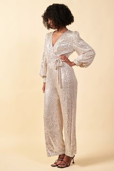 There's no denying the statement-making power of a fully sequined jumpsuit. With puffed sleeves, slightly flared legs, and a waist-defining self-tie belt, this wrap-style number is primed to turn heads at your next night-out occasion. AVAILABLE IN PLUS •Wrap-style bodice •Puffed long sleeves •Cuffs with covered buttons •Optional self-tie belt •Slightly flared legs •Hidden zipper at back Item number 73574 97% Polyester 3% Spandex Sequined Jumpsuit, Puffed Long Sleeves, Tie Waist Jumpsuit, Wrap Jumpsuit, Sequin Jumpsuit, Belt Tying, Puffed Sleeves, Tie Belt, Covered Buttons