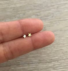 Teeny Tiny STAR Studs. They are super cute! * 1 pair * 14k Gold & Gold Filled * Star Size: 3.5 mm * Made in U.S.A. Tiny Gold Star Cartilage Earrings, Gold Star-shaped Dainty Cartilage Earrings, Gold Dainty Star Cartilage Earrings, Dainty Gold Star Cartilage Earrings, Tiny Star Earrings For Everyday, Tiny Star Earrings For Everyday Wear, Tiny Star-shaped Earrings For Gifts, Tiny Star-shaped Earrings As A Gift, Tiny Star-shaped Earrings For A Gift