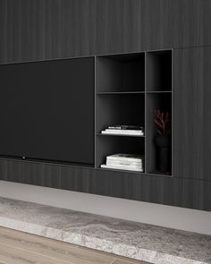 an entertainment center with black cabinets and shelves