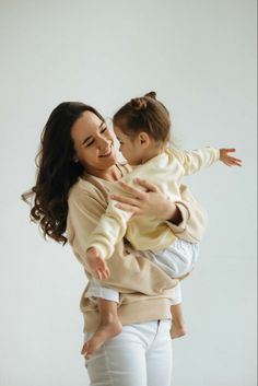 a woman holding a baby in her arms