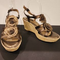 Wow! Beautiful Bronze Leather Floral Sandals By Strictly Comfort In New Never-Worn Condition Without Tags. - Bronze Metallic Leather Uppers - Super Padded Footbed - Cute Formed Leather Flower Front Detail - Buckle Ankle Strap - 1 1/2" Platform 3 1/2" Burlap Wrapped Wedge Heel - Rubber Outsoles - Condition...New Never-Worn Condition Without Tags Or Box. No Scuffs Or Defects Visible. Please See Pics For Condition - Non-Smoking Home - Quick Ship Seller With A 5-Star Rating I Welcome Reasonable Offe Elegant Brown Wedge Sandals For Vacation, Floral Wedges, Floral Sandals, Leather Flower, Leather Floral, Leather Flowers, Star Rating, Metallic Leather, Wedge Heels