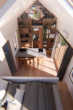 an aerial view of a bed and desk in a small room