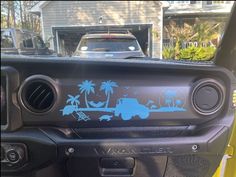 a truck is parked in front of a house with palm trees and beach scene decals on it