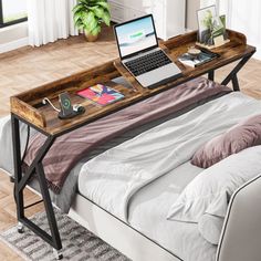 a laptop computer sitting on top of a wooden desk in front of a bed with white sheets