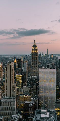 an aerial view of new york city at dusk with the empire building in the foreground