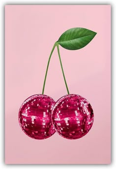 two shiny red cherries hanging from a green leaf on a pink background with reflections