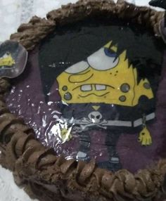 the cake is decorated with an image of cartoon characters on it's chocolate icing