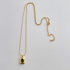 Add a touch of elegance to any outfit with our Emerald Necklace. Featuring a brilliant green CZ stone and multiple layers of 14k gold plating, this 18" necklace is both waterproof and anti-tarnish for everyday wear. Perfect for any occasion. Green Dainty Clavicle Chain Necklace, Everyday Green Jewelry With Clavicle Chain, Gold Emerald Necklace For Everyday Wear, Dainty Green Clavicle Chain Necklace, Green Gold Plated Jewelry With Delicate Chain, Gold Plated Tarnish Resistant Necklace With May Birthstone, Everyday Green Gold-plated Jewelry, Green Chain Necklace With Adjustable Chain, Gold Plated Tarnish Resistant Necklace For May Birthstone