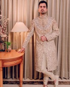 we suggest you first check out these 30+ grooms outfits which are trendy traditional. Each outfit is beautifully styled and worn which is exactly how it should be! So, without further wasting time let's check out these best groom outfits #shaadisaga #indianwedding #groomoutfit #groomoutfitideas #punjabigroomoutfits #groommensoutfits #indiangroomoutfits #suitforgroom #kurtaforgroom #indowesterngroomoutfit #groomoutfitsangeet #groomoutfitswedding #groomoutfithaldi #sherwaniforgrooms #sherwani Ivory Sherwani, Groom Colours, Sherwani For Groom, Groom Pose, Dapper Grooms, Offbeat Wedding, Dapper Outfit, Sherwani Groom