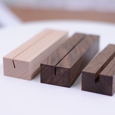 three pieces of wood sitting on top of a white table