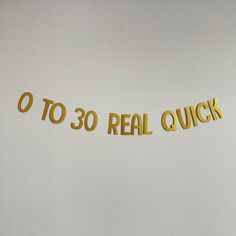 a banner that says o to 30 real quick hanging on the wall in front of a white wall