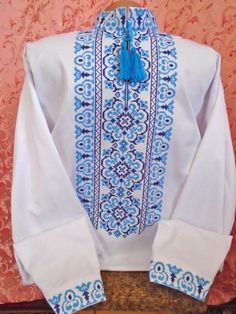 a white shirt with blue trim and tassels