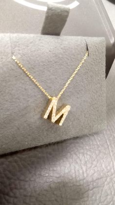 A 14-carat gold letter necklace features a delicate and elegant design, typically crafted from high-quality yellow or white gold. The necklace usually consists of a fine chain that supports a pendant in the shape of a letter, representing initials or names. The letter pendant can be polished for a shiny finish or have a textured surface for added interest. This versatile piece can be worn alone for a minimalist look or layered with other necklaces for a trendy style. It's perfect for everyday we 14k Gold Initial Necklace, Gold Initial Necklace, Gold Letter Necklace, Gold Letter, Initial Necklace Gold, Gold Initial, Letter Pendants, Gold Letters, Trendy Style