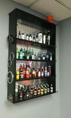 a wall mounted shelf filled with lots of bottles