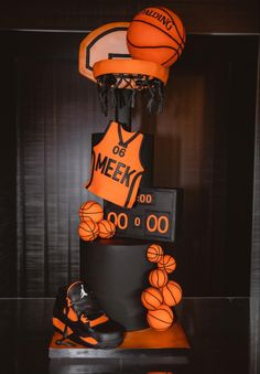 a cake made to look like basketballs and shoes on top of a black table