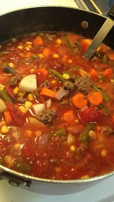 a pot filled with soup sitting on top of a stove