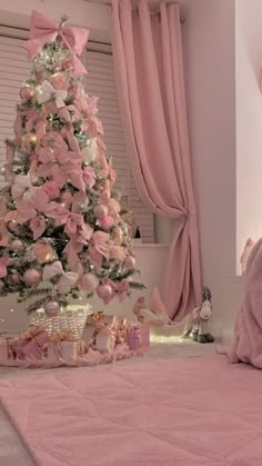 a pink christmas tree in the corner of a room