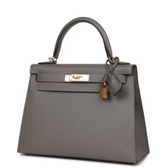 This Kelly, in the Sellier style, is in Gris Meyer epsom leather with gold hardware and has tonal stitching, front flap, two straps with center toggle closure, clochette with lock and two keys a single rolled handle and removable shoulder strap.The interior is lined with Gris Meyer chevre leather and has one zip pocket with an Hermes engraved pull and two open pockets on the opposite side.Collection: UOrigin: FranceCondition: New and never worn (plastic on hardware)Accompanied by: Hermes box, He Hermes Kelly Sellier, Kelly Sellier, Luxury Bags Collection, Hermes Box, Kelly Bag, Timeless Luxury, Quiet Luxury, Hermes Bags, Louis Vuitton Bags