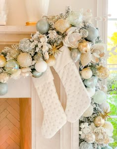 a decorated christmas mantle with stockings and ornaments