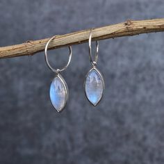 ✦ Make a bold statement with these beautiful Moonstone marquise hoop earrings! Handcrafted with sterling silver, each pair features two sterling silver marquise hoops, accented by shimmering moonstone stones. The unique cut of the stones catches the light in a stunning and eye-catching way. The moonstone has long been held as a sacred and spiritual stone, understood to be a gift from the mysterious goddess of the full moon. Said to bring peace, harmony and balance to its wearer's life, these ear Silver Dangle Hoop Earrings With Gemstones, Moonstone Stone, Crystal Dangle Earrings, Sparkly Earrings, Moonstone Earrings, Dangly Earrings, Raw Gemstones, Dream Jewelry, Healing Crystals