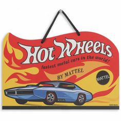 a hot wheels sign hanging on a wall next to a black cord with the words,'hot wheels fastest metal cars in the world by mattel '