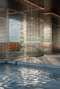 an empty swimming pool with wooden slats covering the walls