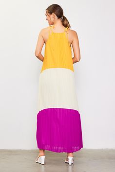 A breezy maxi dress is a must-have in hot weather, and this colorblocked version demands attention. It's bold, fun, and flowy, designed with a shoulder-baring halter neckline, dainty ties, and a cascade of pleats. •Halter neckline with self-ties •Front cutout •Pleated Item Number: 99171 Sleeveless Color Block Summer Maxi Dress, Blue Sleeveless Color Block Maxi Dress, Summer Pleated Pre-draped Maxi Dress, Summer Tie-dye Halter Neck Dress, Summer Color Block V-neck Maxi Dress, Color Block Maxi Dress, Halter Neckline, Hot Weather, In Hot