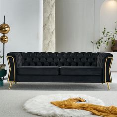 a black and gold couch in a white room with fur rugs on the floor