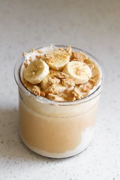 a dessert in a glass with banana slices on top