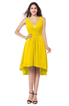 a woman in a yellow dress posing for the camera with her hands on her hips