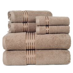 six towels stacked on top of each other in tan and white stripes, with one folded