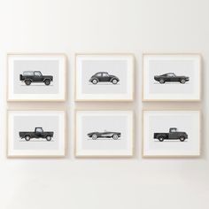 four black and white photographs of cars mounted on the wall in front of each other