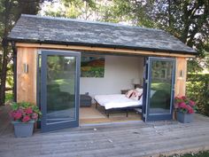 an outdoor room with sliding glass doors on the outside