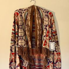 Super Soft, Lightweight Cotton Knit Cardigan/Shawl In Gorgeous Southwestern Pattern With Angled, Open Front And Fringe Along Edges And Hem. Sleeves Have Ribbed Cuffs. Drapes Beautifully And Adds A Southwestern Flair To Jeans Or A Skirt! Size M Length: 32” Back, 38” Front At Longest Point (Including Fringe) Pit To Pit: 22” (Designed To Be Roomy) About Tasha Polizzi / T.P. Saddleblanket Co. Tasha Polizzi Was An American Designer With A Lifelong Interest And Respect For Native American Culture. She Fringe Long Sleeve Cardigan For Festivals, Multicolor Tassel Shawl For Fall, Bohemian Shawl Sweater For Fall, Fall Bohemian Shawl Sweater, Fall Shawl With Tassels, Traditional One-size Outerwear For Fall, Fitted Bohemian Outerwear With Tassels, Fall Tassel Shawl, Traditional Multicolor Cardigan For Fall