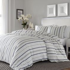 a bed with blue and white striped comforter