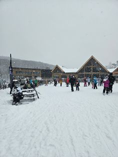 a group of people standing around in the snow