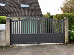 a gated driveway leading to a house