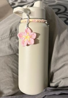 a white water bottle with a pink flower on it