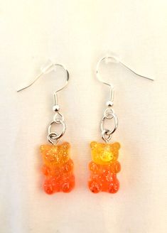 the earrings have been made to look like gummy bears, and are hanging from silver hooks