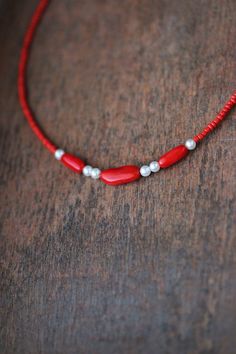 This feminine delicate necklace was made of 3 natural red coral stone beads, 6 white pearl coated pastic beads, tiny red irregular shape glass seed beads, stainless steel end clasps, double strong nylon thread, stainless steel lobster claw and stainless steel adjustable length chain. You can wearing it with other necklaces or alone! The length of necklace is about 41 cm or about 16.1 inches and about 5 cm of adjustable length stainless steel chain. Other necklaces of my shop you can see here: https://www.etsy.com/shop/NaTavelli?section_id=14843046&ref=shopsection_leftnav_5 Thanks for a visit. Red Coral Beaded Necklace With Spacer Beads, Red Beaded Necklaces For Jewelry Making, Red Pearl Beaded Necklaces For Jewelry Making, Red Minimalist Beaded Necklace With Tiny Beads, Red Pearl Beaded Necklace With Round Beads, Red Pearl Jewelry With Colorful Beads, Red Pearl Necklace With Polished Beads As A Gift, Minimalist Red Beaded Necklace With Tiny Beads, Minimalist Red Beaded Necklaces