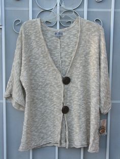 NWT ~ JM COLLECTION 2 Button Marbled Tan COASTAL NOUVEAU Cardigan Sweater Sz Large This JM Collection is light, airy, soft and comfy! Sweater is short sleeved and size L. Made in China and is 75% cotton, 23% polyester and 2% metallic material. Measures about 22" from underarm to underarm and 25" from top of collar to bottom of hem with sleeve inseam of about 8”. Color is flax. Brand new with tags and includes some extra thread and an extra button. MSRP is $59.50. Please review photos for details Cozy Button-up Tops With Buttons, Summer Cardigan With Buttons For Layering, Casual Cardigan With Buttons For Loungewear, Casual Buttoned Cardigan For Loungewear, Cozy White Tops With Buttons, Beige Buttoned Cardigan For Day Out, Cozy Spring Top With Buttons, Beige Summer Cardigan With Buttons, Cozy Spring Tops With Button Closure