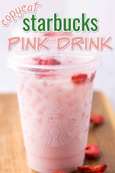 a pink drink in a plastic cup with strawberries on the side and text overlay that reads, copycat starbucks pink drink