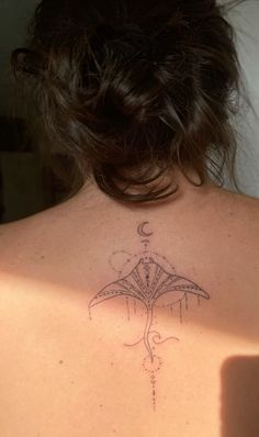 a woman with a tattoo on her back