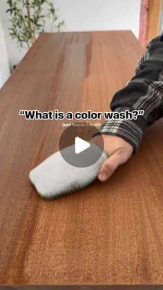 a person using a brush to clean a wooden table top with text overlay that reads, what is a color wash?