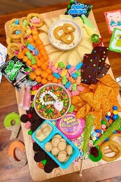 a wooden table topped with lots of food and snacks on top of eachother