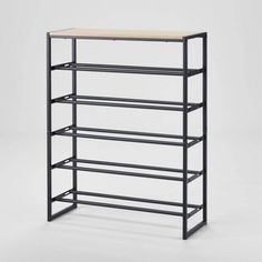 the shelf is black and has three shelves on each side, one with a wooden top