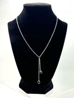 Add a touch of elegance to your outfit with this beautiful Sterling Silver Birthstone Lariat Necklace. The necklace is made of 925 silver and features a stunning combination of Peridot, Topaz, and Amethyst stones. The lariat style of the necklace is perfect for adding a touch of sophistication to any outfit. This necklace is a great addition to your jewelry collection and is perfect for any occasion. The combination of the three stones, Peridot, Topaz, and Amethyst, makes this necklace a unique and beautiful piece. Order now and add this stunning necklace to your collection. Silver Lariat Necklace, Amethyst Stones, Stunning Necklace, Lariat Necklace, Amethyst Stone, Three Stone, Topaz, 925 Silver, Jewelry Collection