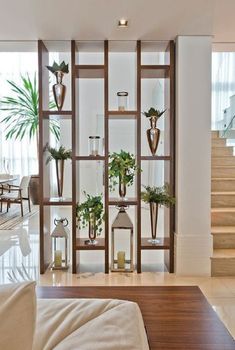 a living room filled with furniture and lots of plants